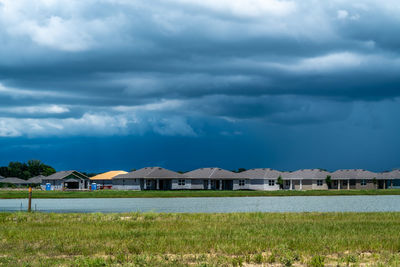 Houses on field against sky