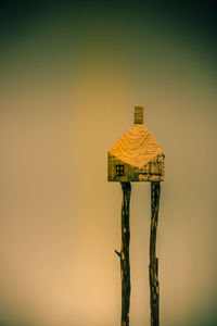 Close-up of stilt house against clear sky