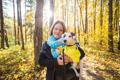 Young woman with dog in the forest