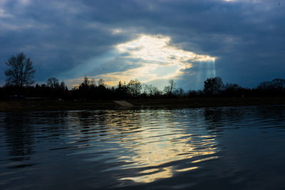 Scenic view of lake against sky at sunset