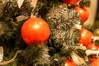 Close up of christmas tree decoration with baubles and garland. festive greeting card for winter 