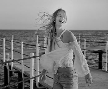 Smiling woman standing at beach