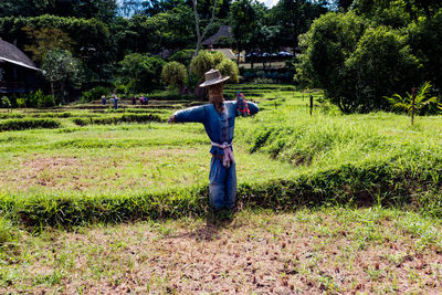 Full length of man climbing on grass