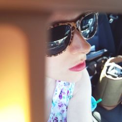 Close-up of young woman in sunglasses