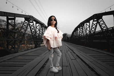 Woman standing on bridge