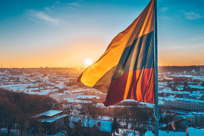 Panoramic shot of buildings in city during sunset