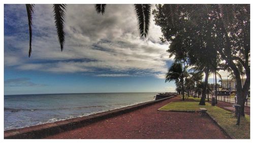 View of beach against cloudy sky