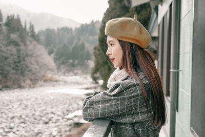 Side view of young woman looking at mountains