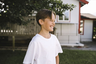 Portrait of smiling man standing against built structure