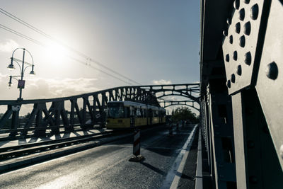 Railway bridge in city against sky