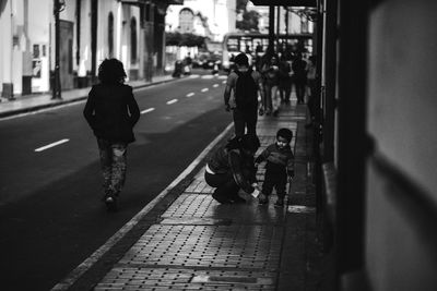 People walking on sidewalk in city