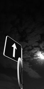 Low angle view of road sign against sky