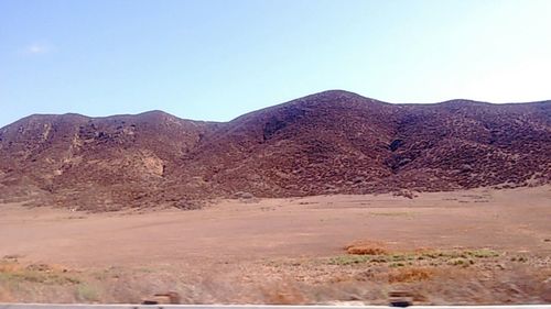 Scenic view of rocky mountains against clear sky