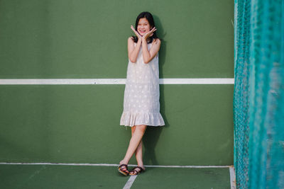 Woman standing against wall