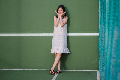 Woman standing against wall