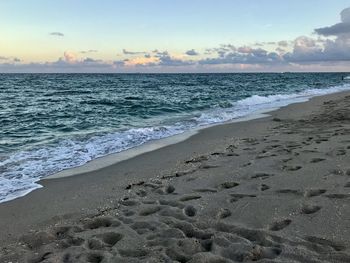 Scenic view of beach against sky during sunset