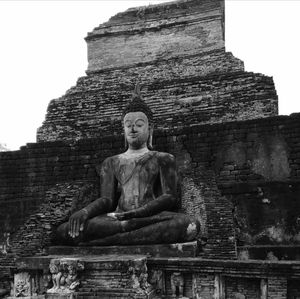 Low angle view of statue against old building