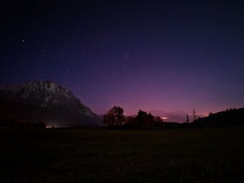 Scenic view of field against sky at night