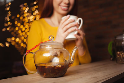 Woman brews tea, delicious aroma, appetizing. white porcelain cup, drink, tea shop. 