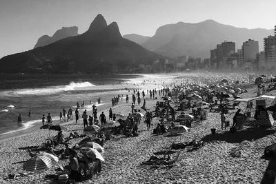 People at beach against sky