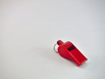 Close-up of red toy over white background