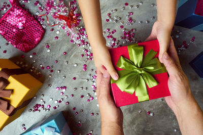 Directly above shot of hands holding gifts