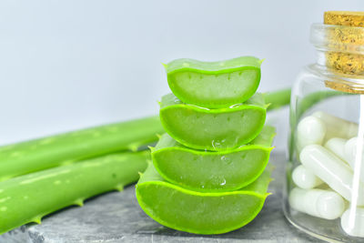 Close-up of green jar on white background