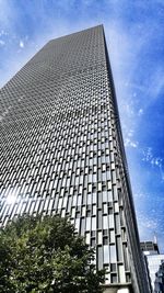 Low angle view of building against cloudy sky