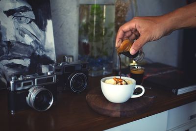 Midsection of man pouring coffee in cup