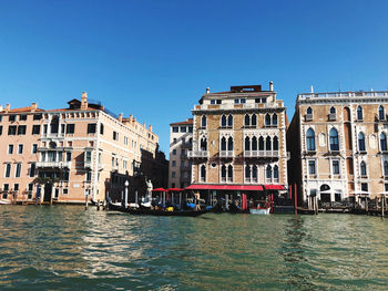 View of buildings in city against clear sky