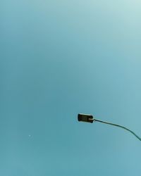 Low angle view of street light against blue sky