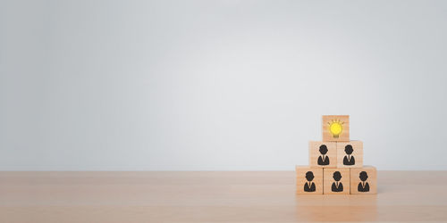 Stack of stuffed toy on hardwood floor against white background