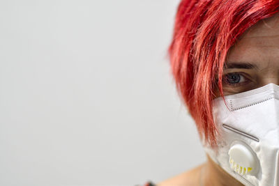 Close-up portrait of a serious young woman over white background