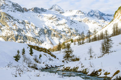 Scenic view of snow covered mountains against sky