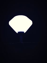 Low angle view of illuminated lamp against dark background