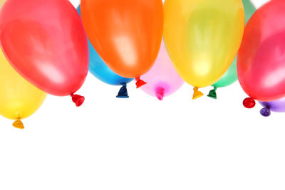 Low angle view of balloons against white background