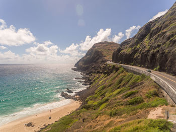 Scenic view of sea and mountains against sky