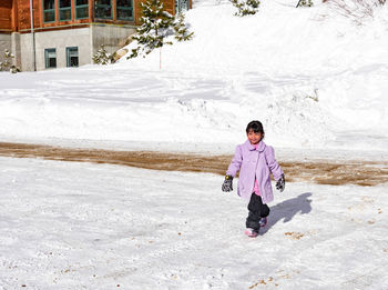 Full length of young man standing on snow