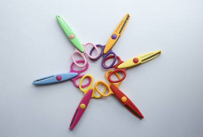 High angle view of multi colored pencils on white background