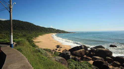 View of calm beach against blue sky