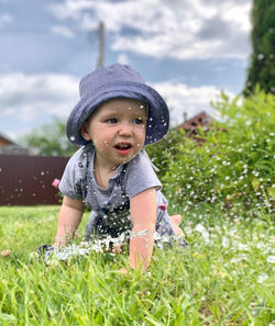 Portrait of cute baby girl on field