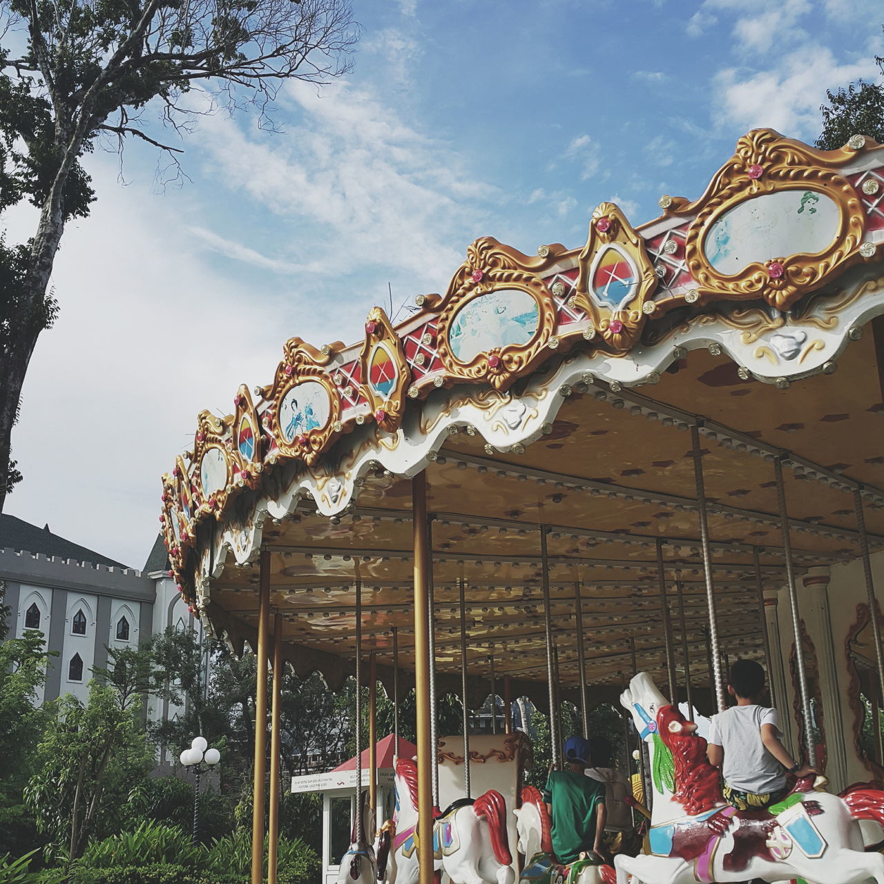 LOW ANGLE VIEW OF CAROUSEL AGAINST SKY