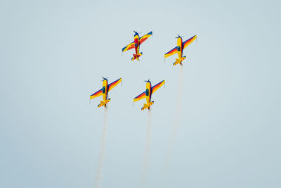 Low angle view of airshow against clear sky