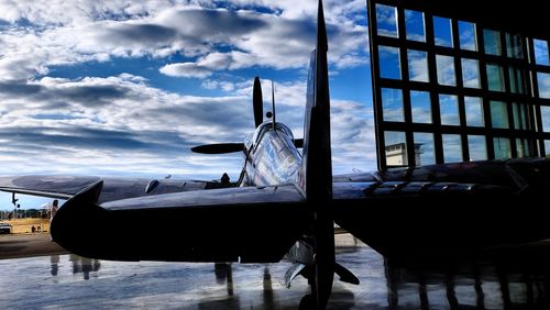 Airplane on runway against sky