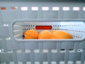 Close-up of orange slices in container