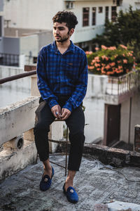 Full length of man standing against wall