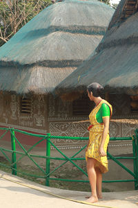 Full length side view of woman standing on mountain