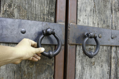 Close-up of hand with closed door