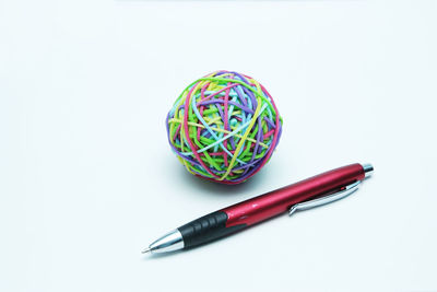 High angle view of colored pencils on table against white background