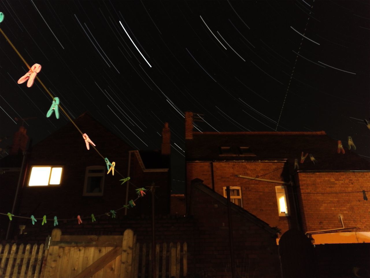 VIEW OF ILLUMINATED HOUSE AT NIGHT